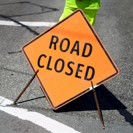 Orange diamond-shaped Road closed sign
